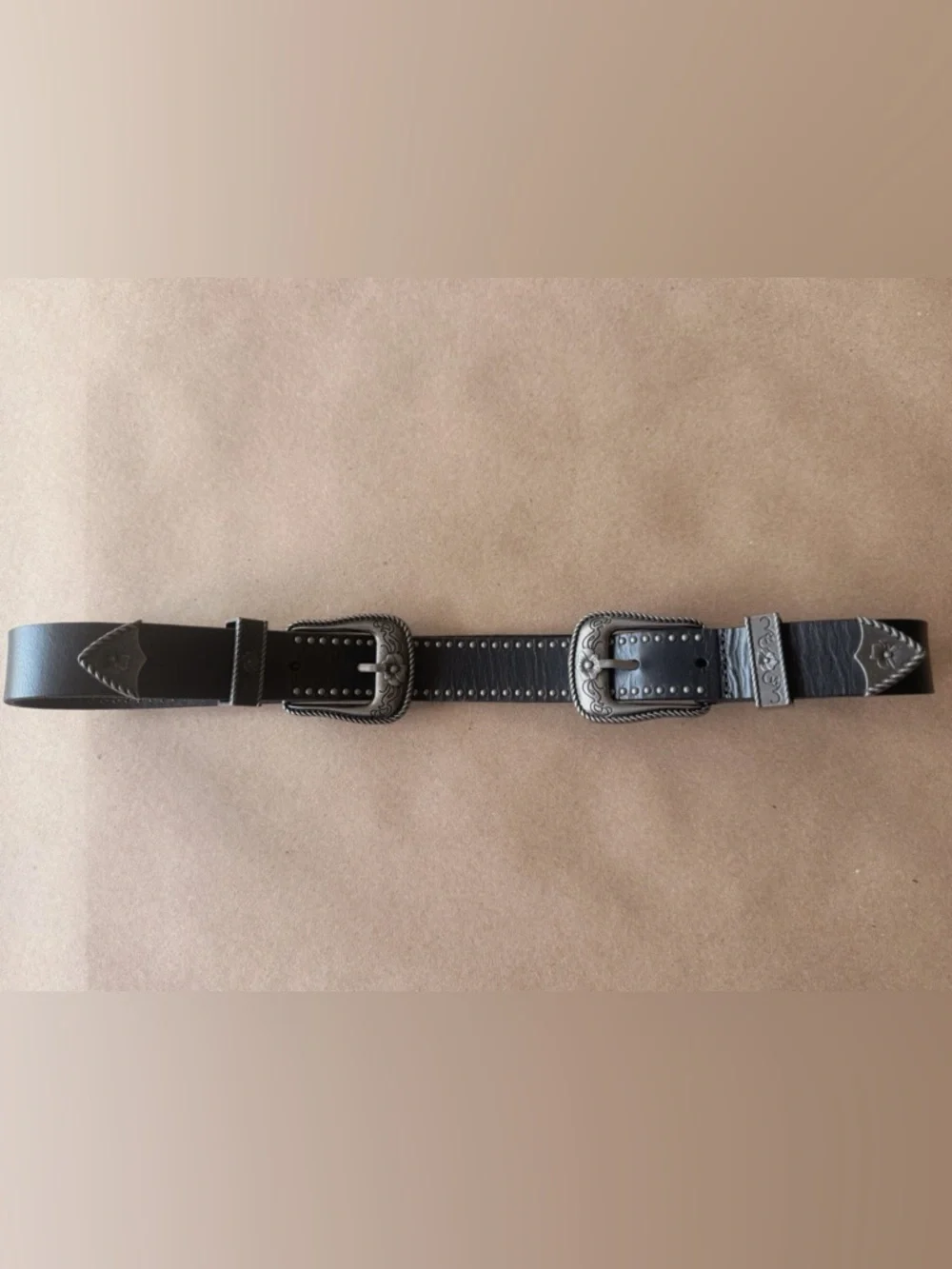 Boutique item with premium craftsmanship and distinctive double buckle design.